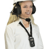 Young blonde woman wearing a white button-down shirt, smiling and wearing an over-ears industrial headset (for ListenTALK) with a white hard hat