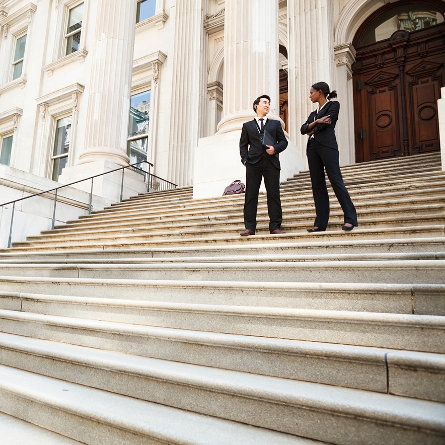 Lawyer and Client or Business People on steps of courthouse