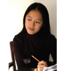 Asian woman writing on paper