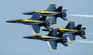 Photo of the Blue Angels jets in the air during an air show.