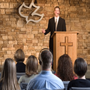 Man speaking to congregation in a church setting