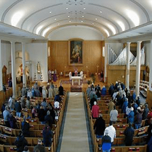 Aerial view of church congregants standing up during a service.