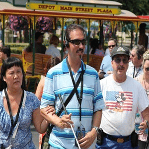 People using assistive listening on a tour in Disneyland