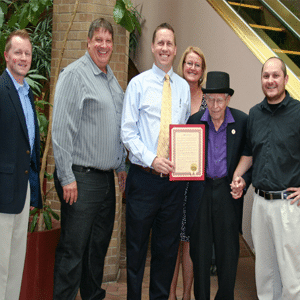 Listen employees posing for a picture with an award