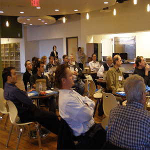 People sitting listening to a speaker in a conference room