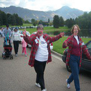 Two happy women wearing white t-shirts and long-sleeved flannel shirts walking to support hearing loss