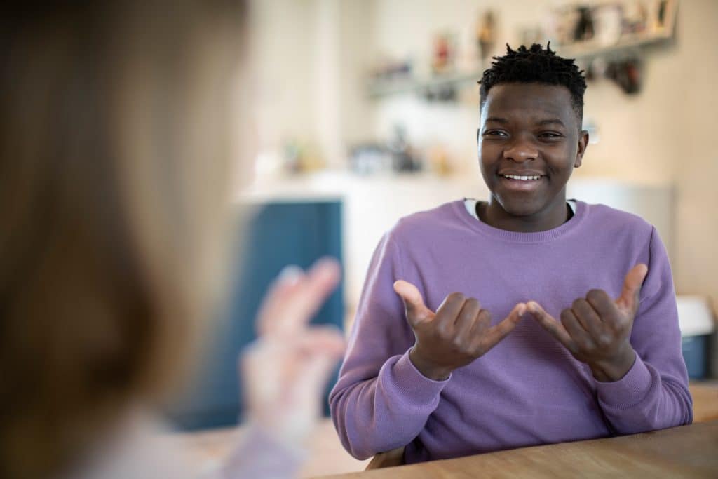 Young African-American man doing sign language