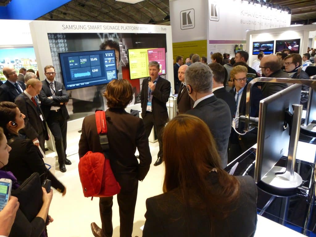 Group of people observing a presentation at a Pro A/V tradeshow.