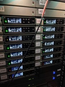 Professional audio rack showing audio sources labeled with the language (i.e. German, French, Hungar, and Czech) with Listen EVERYWHERE servers at the bottom of the rack. 